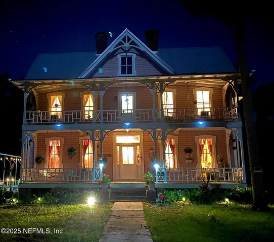 a front view of a house with lots of green space