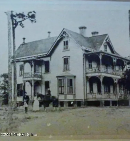 a view of a white house with large windows