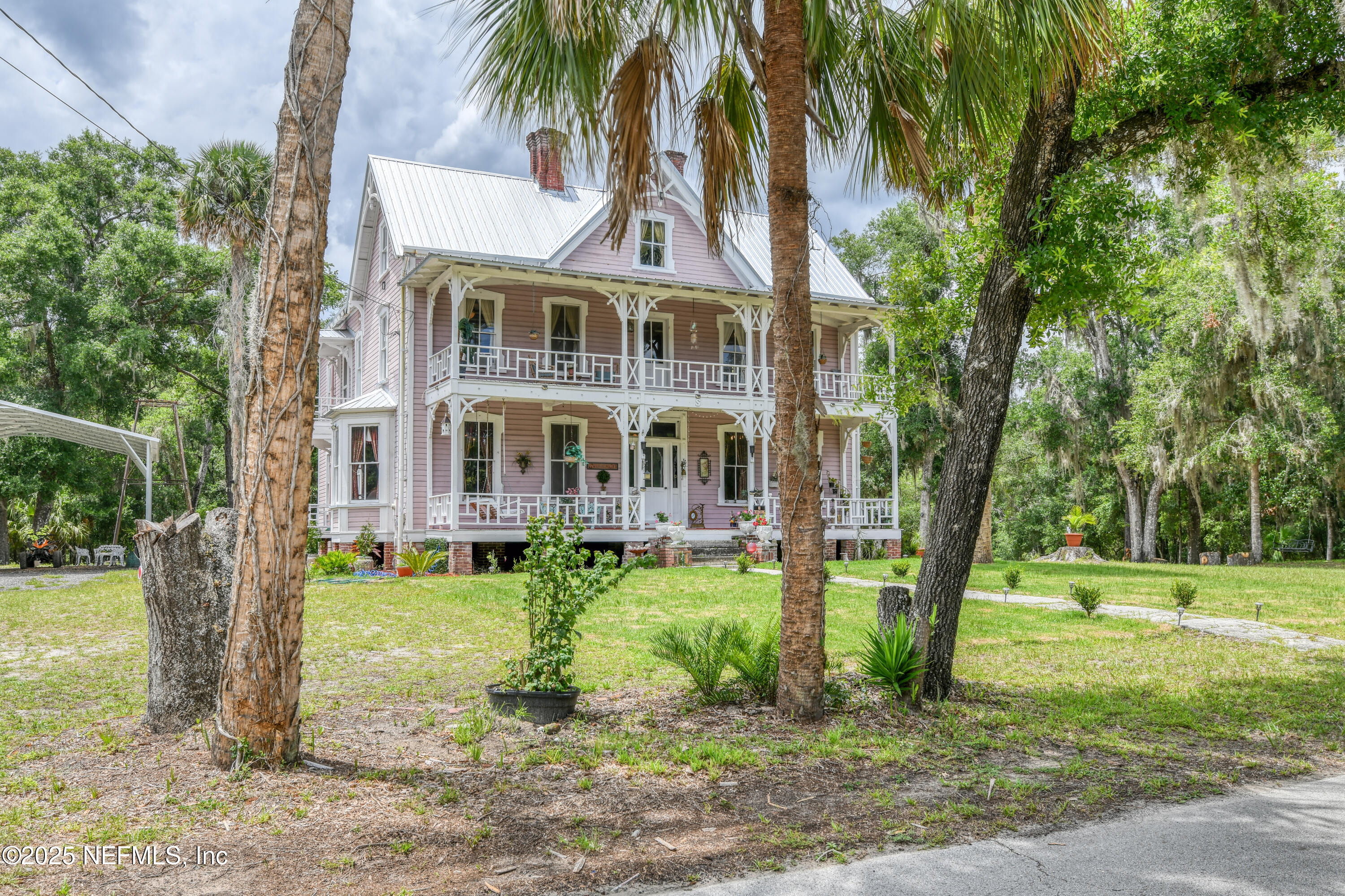 240 Sisco Road Pomona Park, FL 32181 - Photo 4 of 43 a front view of a house with a yard