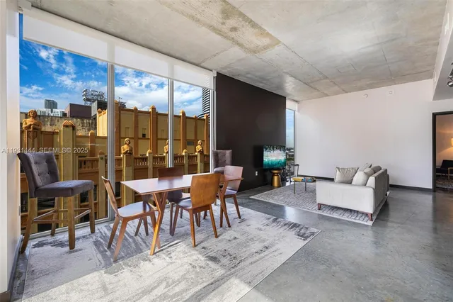 a outdoor space with lots of tables a glass table and chairs