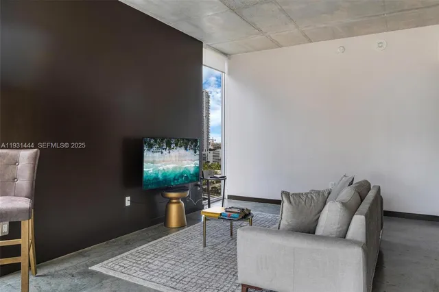 a living room with furniture and a rug