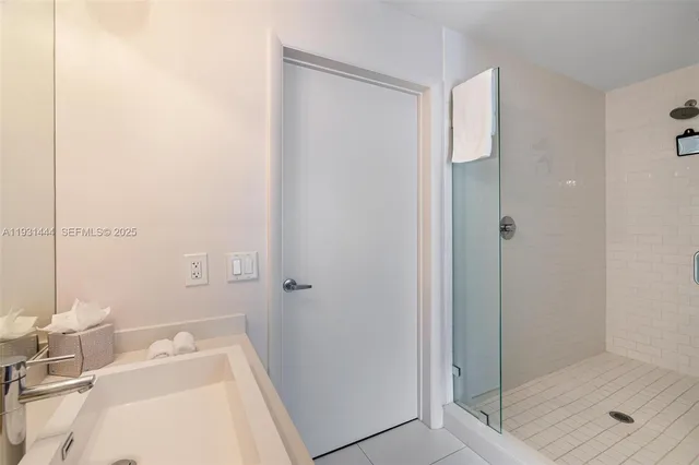 a bathroom with a sink and shower