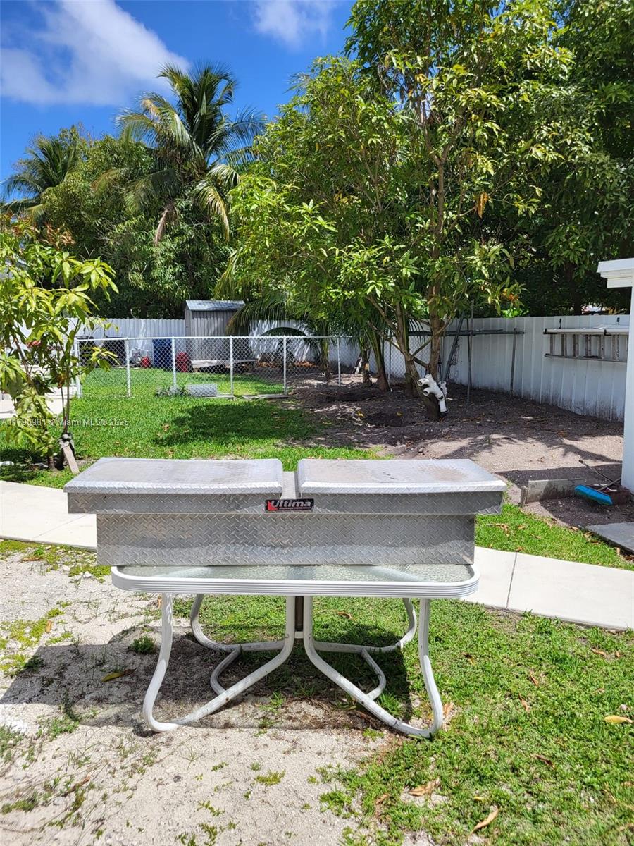 1650 Northeast 147th Street Miami, FL 33181 - Photo 48 of 56 VIEW OF THE FENCE THAT DIVIDES BOTH UNIT AND VIEW OF THE PATIO.