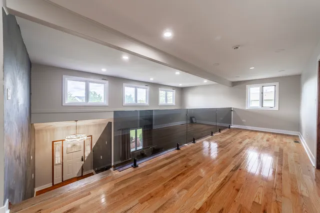 a view of empty room with wooden floor and fireplace