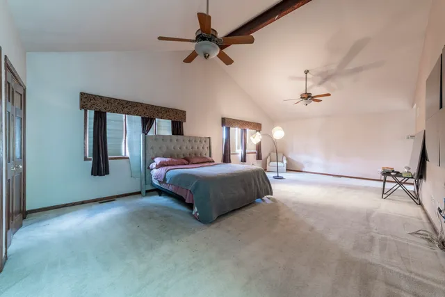 a view of a house with a swimming pool and sitting area