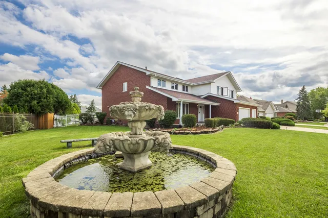a view of a house with backyard sitting area and garden
