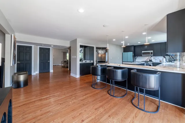 a large kitchen with kitchen island a sink stainless steel appliances and cabinets