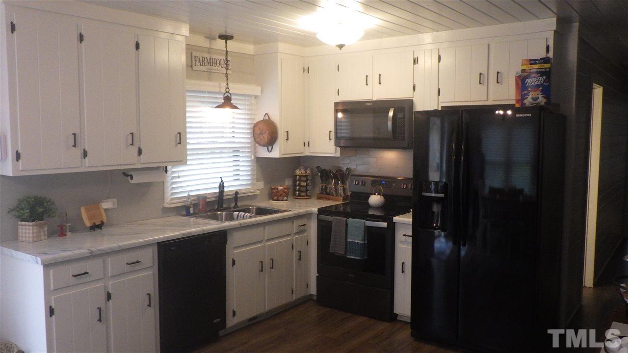 7434 Riley Hill Road Zebulon, NC 27597 - Photo 14 of 23 a kitchen with a sink and cabinets