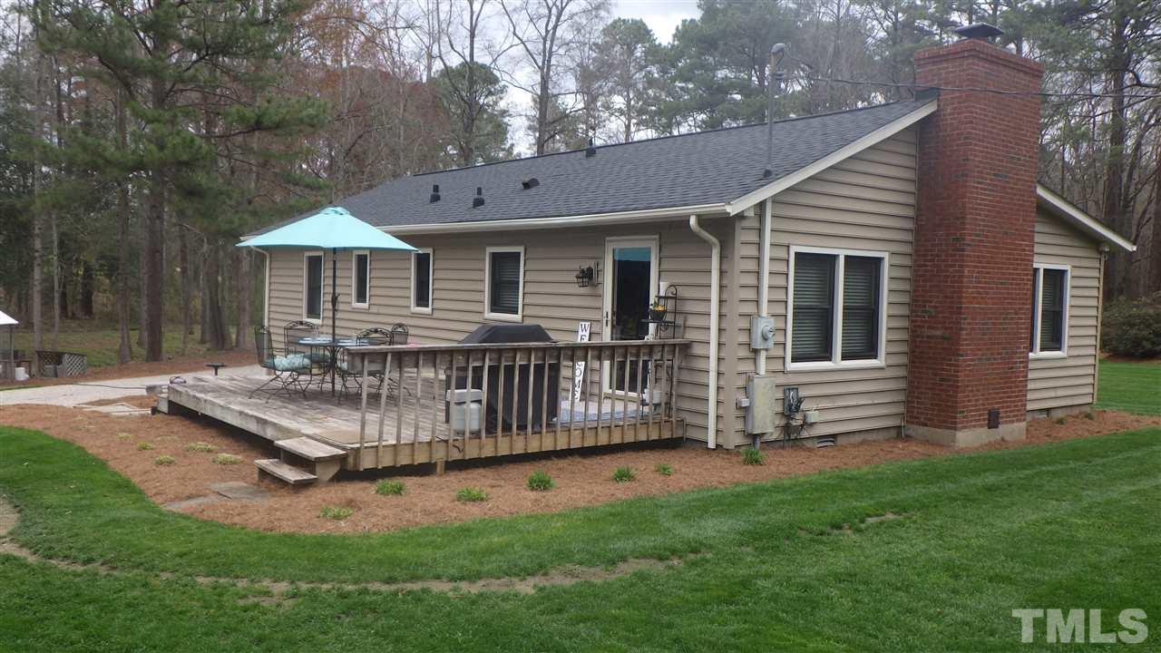 7434 Riley Hill Road Zebulon, NC 27597 - Photo 8 of 23 a view of a house with backyard and a garden