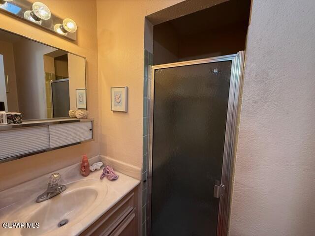 6435 Belton Road El Paso, TX 79912 - Photo 24 of 56 a bathroom with a sink vanity and mirror