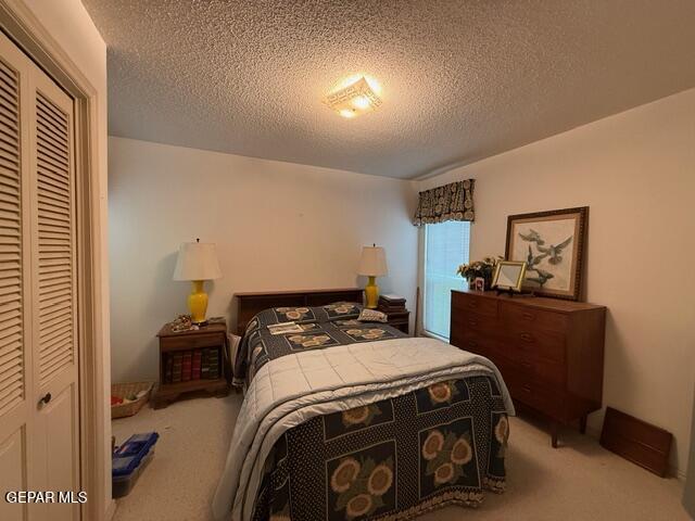 6435 Belton Road El Paso, TX 79912 - Photo 40 of 56 a bedroom with a bed and a dresser in it