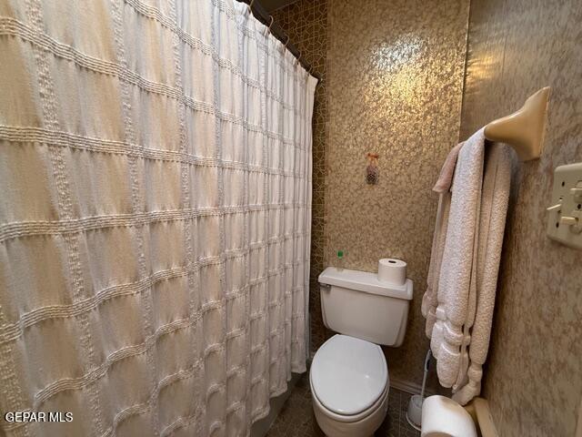 6435 Belton Road El Paso, TX 79912 - Photo 47 of 56 a white toilet sitting next to a shower curtain