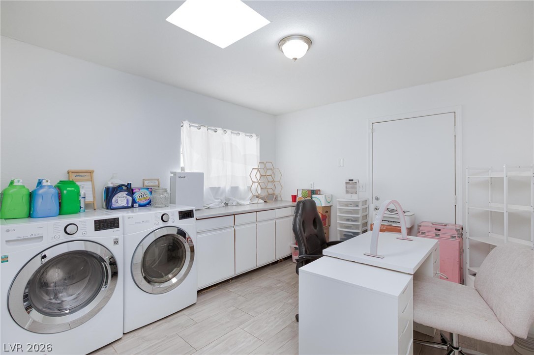3640 North Walnut Road Las Vegas, NV 89115 - Photo 29 of 38 Functional laundry room equipped with dual washer and dryer units, a spacious countertop, and ample cabinet storage.