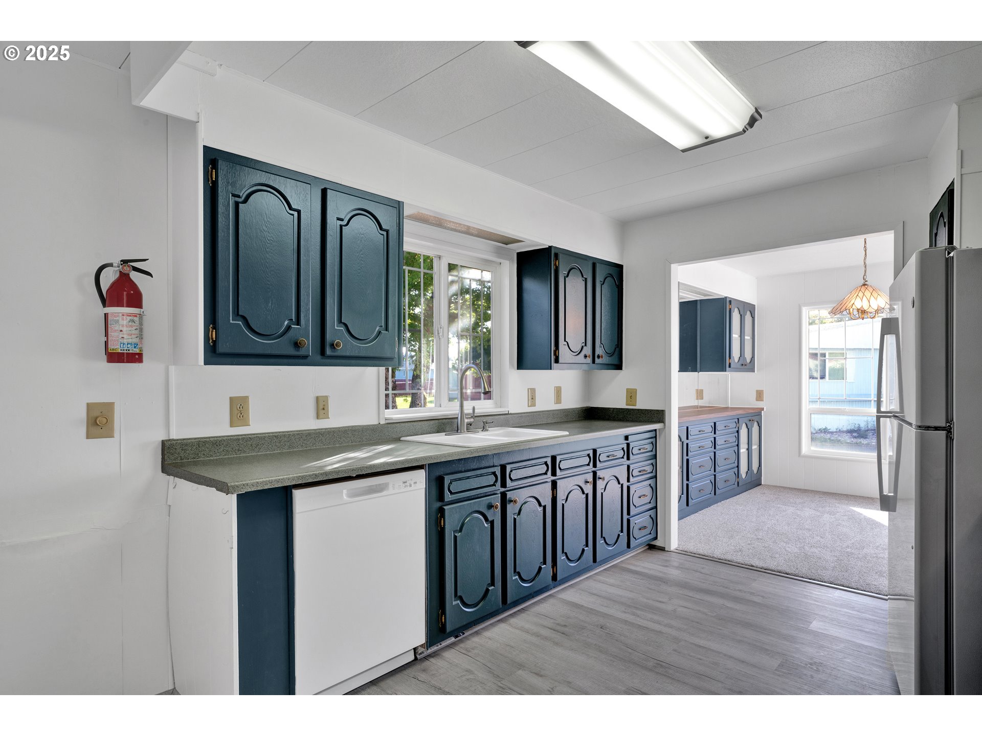 39202 Camp Creek Road, Unit 7 Springfield, OR 97478 - Photo 17 of 39 a kitchen with a sink and a refrigerator