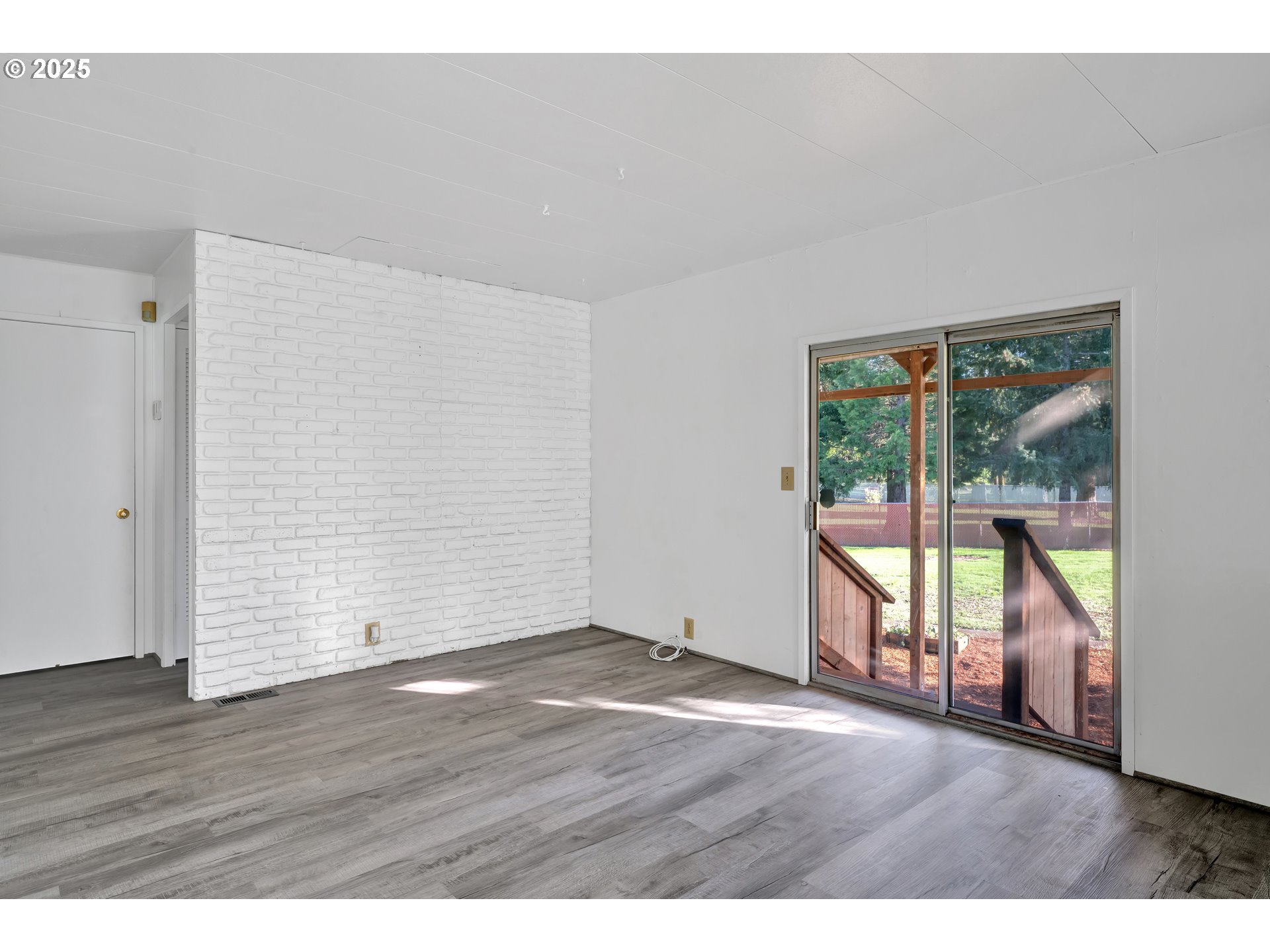 39202 Camp Creek Road, Unit 7 Springfield, OR 97478 - Photo 23 of 39 a view of an empty room with wooden floor and a window