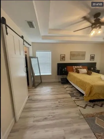 a bedroom with a bed and wooden floor