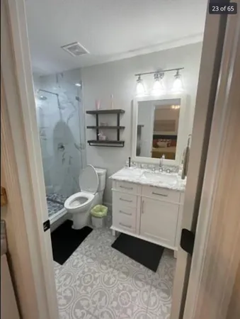 a bathroom with a sink a toilet and shower