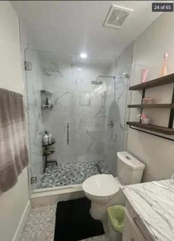 a bathroom with a toilet a sink and shower