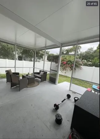a view of an house with backyard space and balcony