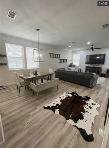 a living room with furniture and kitchen view