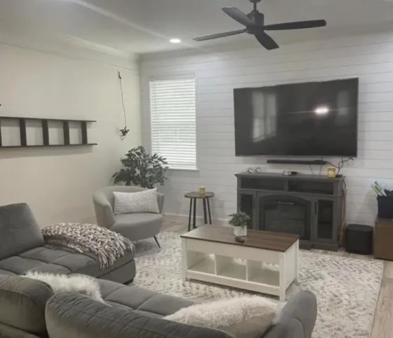 a living room with furniture and a flat screen tv