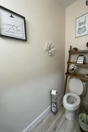 a white toilet sitting next to a bathroom sink