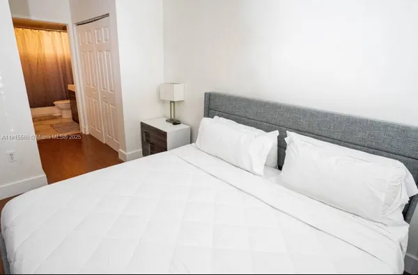 a bedroom with a bed and curtain