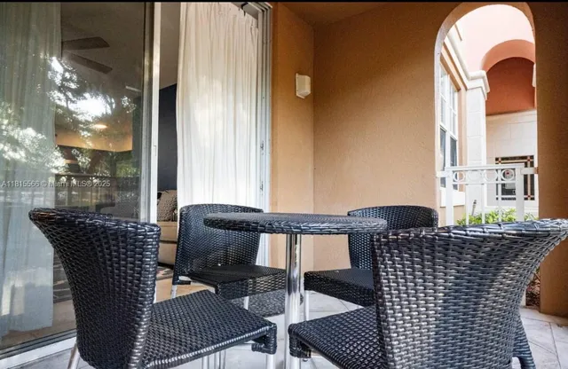 a balcony view with a seating space