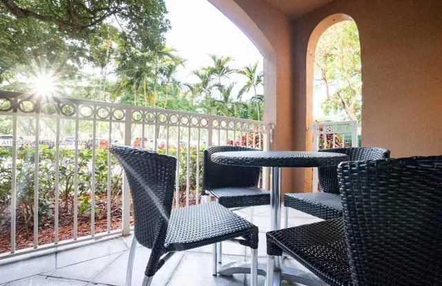 a view of a dining room with furniture and a window