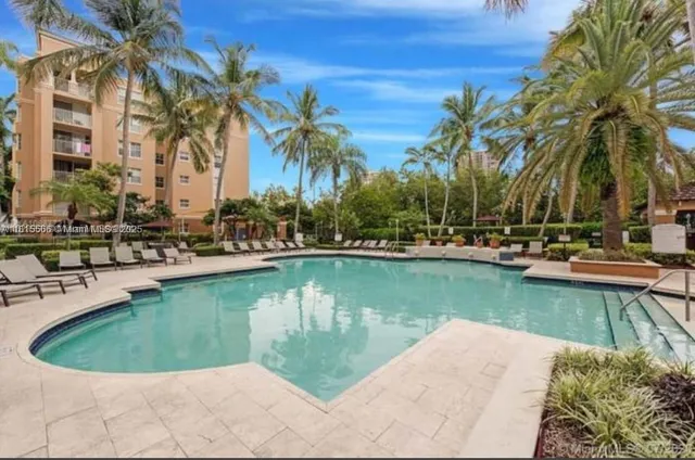 a view of swimming pool with outdoor seating and lake view