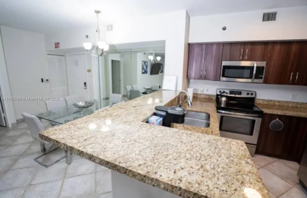 a kitchen with sink cabinets and refrigerator