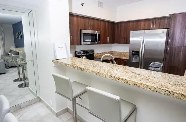 a kitchen with a refrigerator and a sink