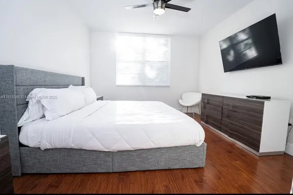 a bedroom with a bed and a flat screen tv