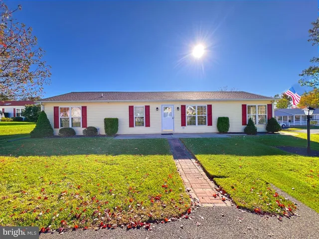 a view of house with swimming pool yard and outdoor seating