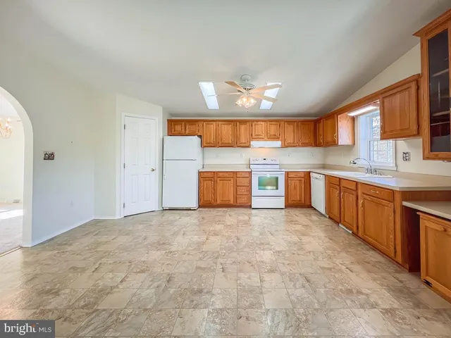a kitchen with stainless steel appliances granite countertop a refrigerator a sink and dishwasher