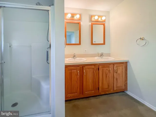 an empty room with a window and a ceiling fan