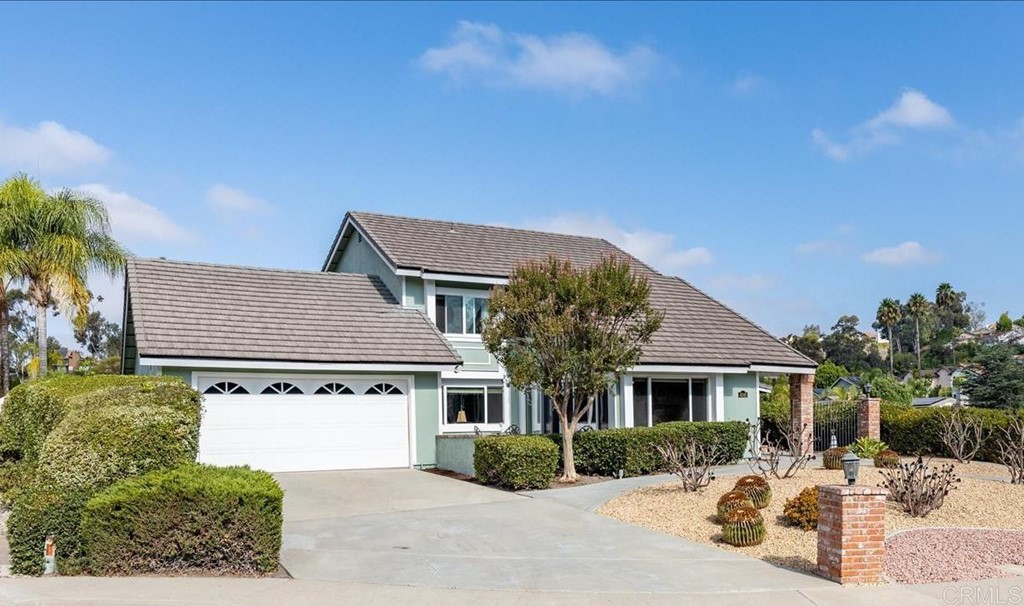 4040 Risa Circle San Diego, CA 92124 - Photo 2 of 43 a front view of a house with a yard and garage