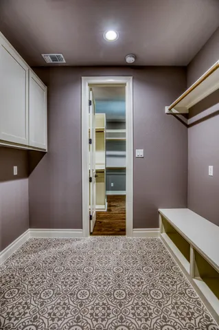 a bedroom with a bed and cabinets