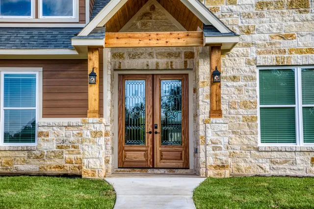 a front view of a house with a garden