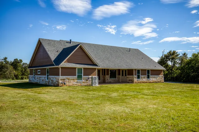 a view of a house with a yard and sitting area