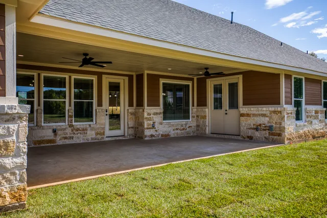 a view of a house with backyard porch and sitting area