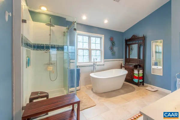 a bathroom with a bathtub and a shower