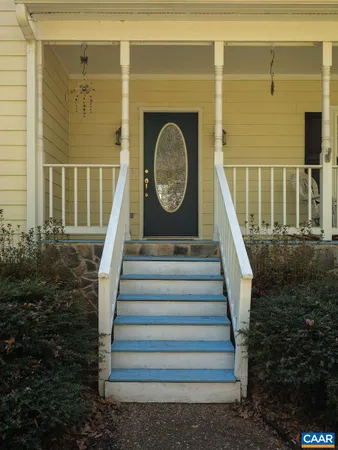 a living room with furniture a couch and a chandelier