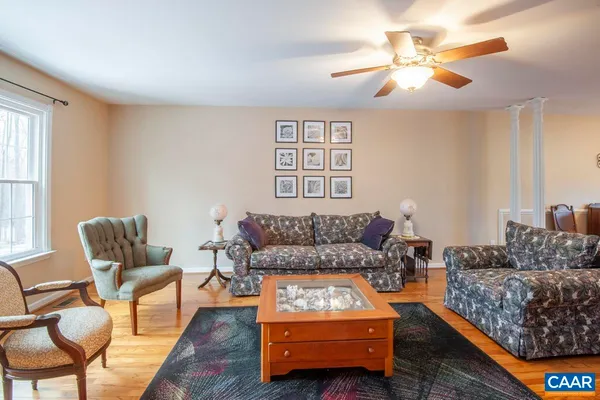 a living room with furniture a couch and a chandelier