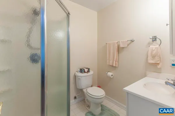 a bathroom with a toilet a sink and shower