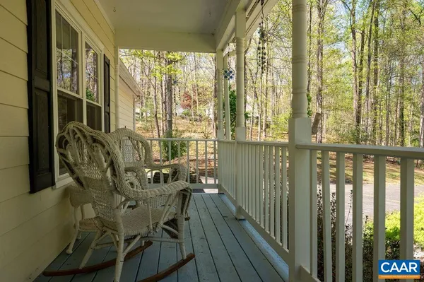 a living room with furniture a fireplace and a dining table