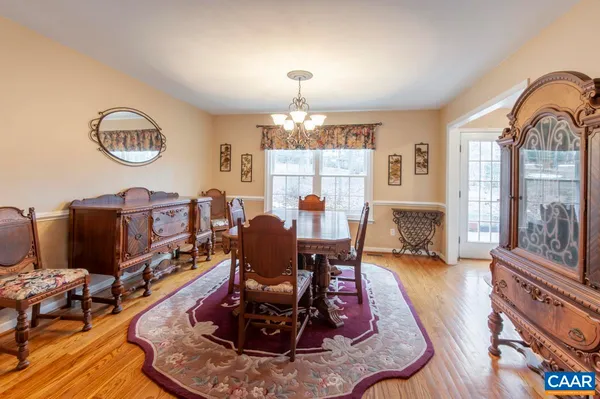 a living room with furniture a fireplace and a dining table