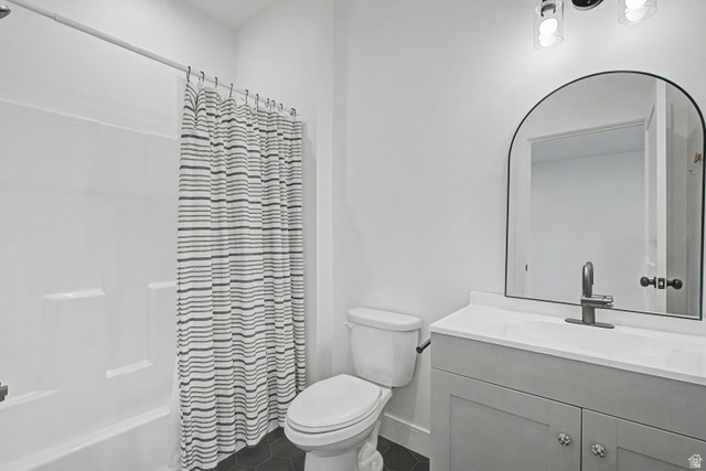 1952 South Comanche Circle Farmington, UT 84025 - Photo 36 of 52 Full bathroom featuring vanity, shower / tub combo, and dark tile patterned flooring