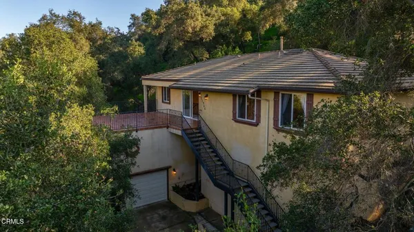 aerial view of a house with yard and trees