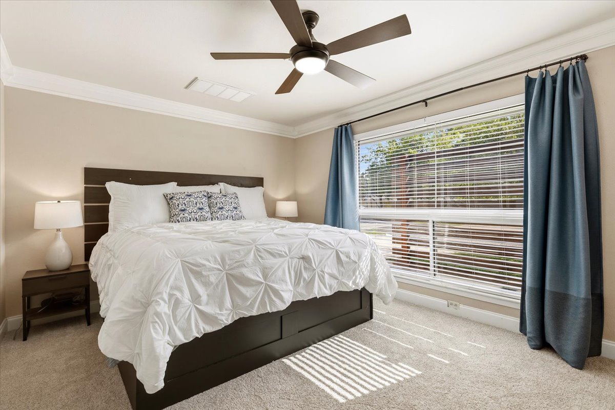 12400 Rusted Nail Cove Austin, TX 78750 - Photo 13 of 31 The main-level primary suite offers privacy and a spacious retreat-like feel.